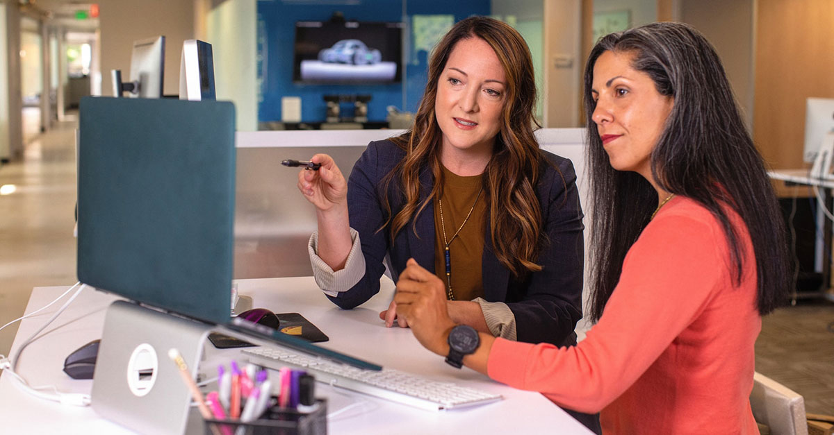 Two women planning in front of a computer screen